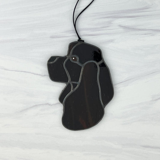 Stained glass Chocolate American Cocker Spaniel dog head suncatcher. This is a side view of the dog looking to the left. The brown is varied with slightly different shades giving depth to the dog.