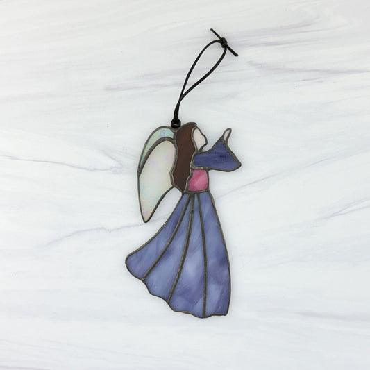 Stained glass angel ornament on a white background. She has a purple dress and sleeve, pink bodice, brown hair and irridescent white wings. Her hand is raised to the right.