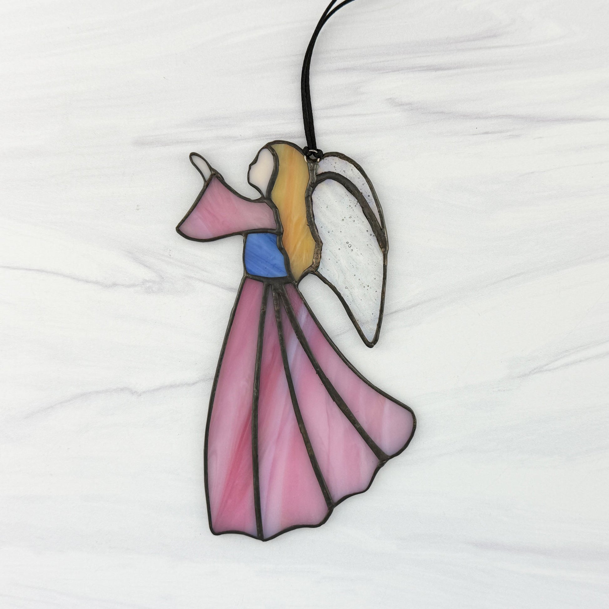 Stained glass angel ornament on a white background with a Pink dress and sleeve, Blue bodice, golden hair, and Iridescent clear wings.