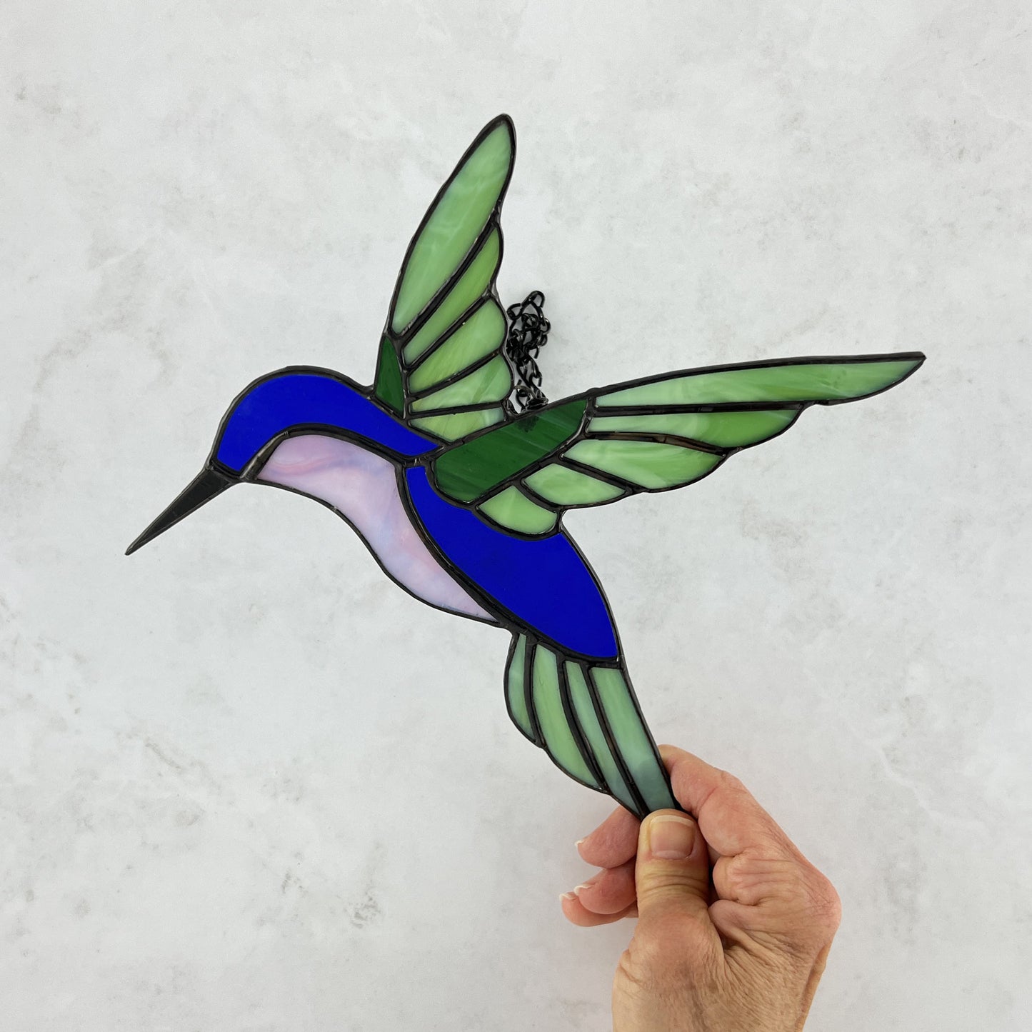 Hovering Hummingbird in Greens, Blue, Pinkish Purple