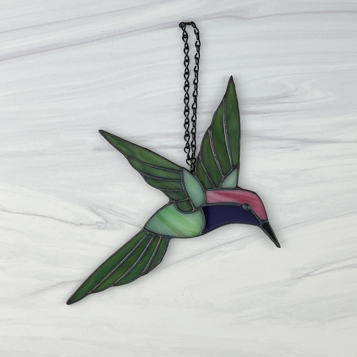 Hovering Hummingbird in Greens, Pink, Purple