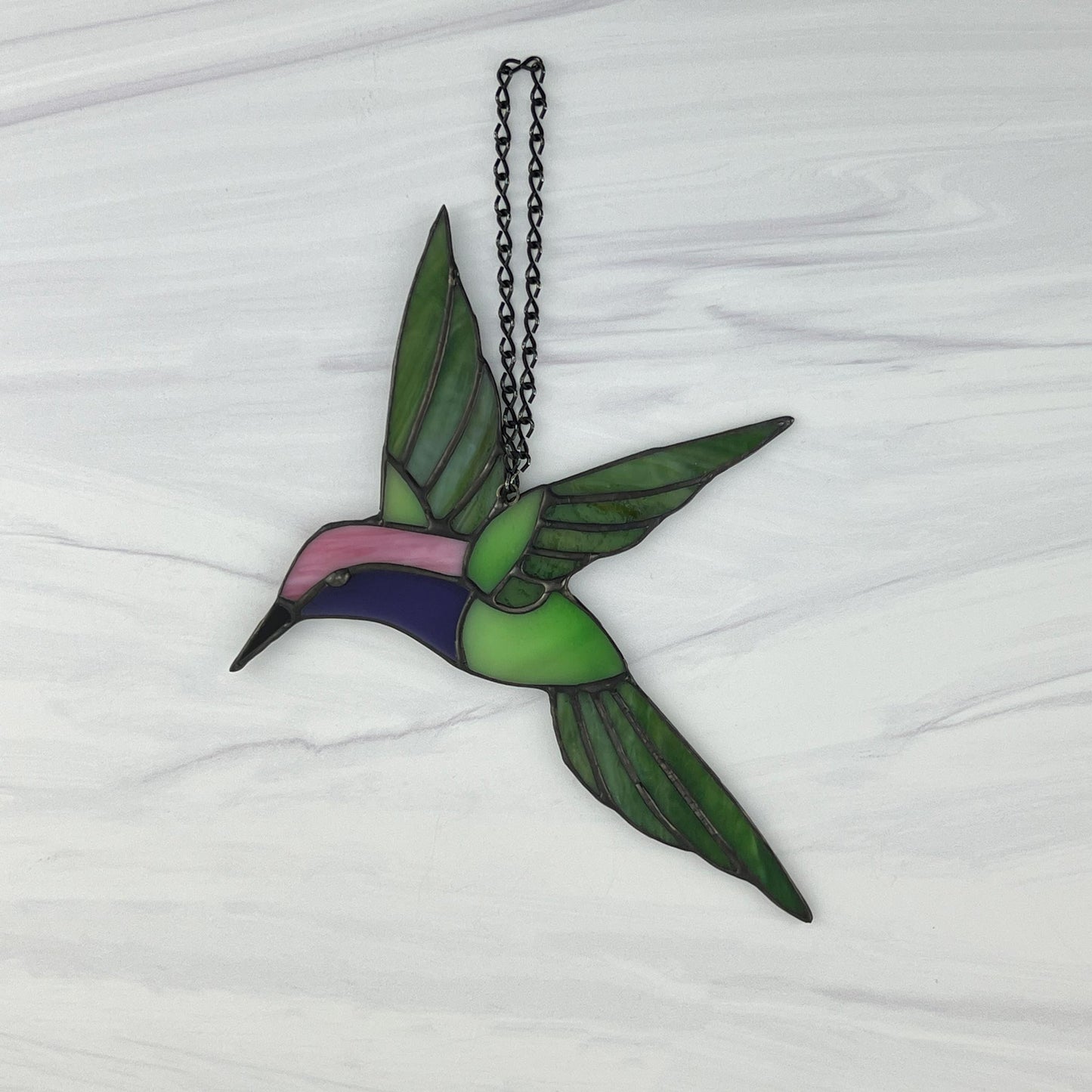 Hovering Hummingbird in Greens, Pink, Purple