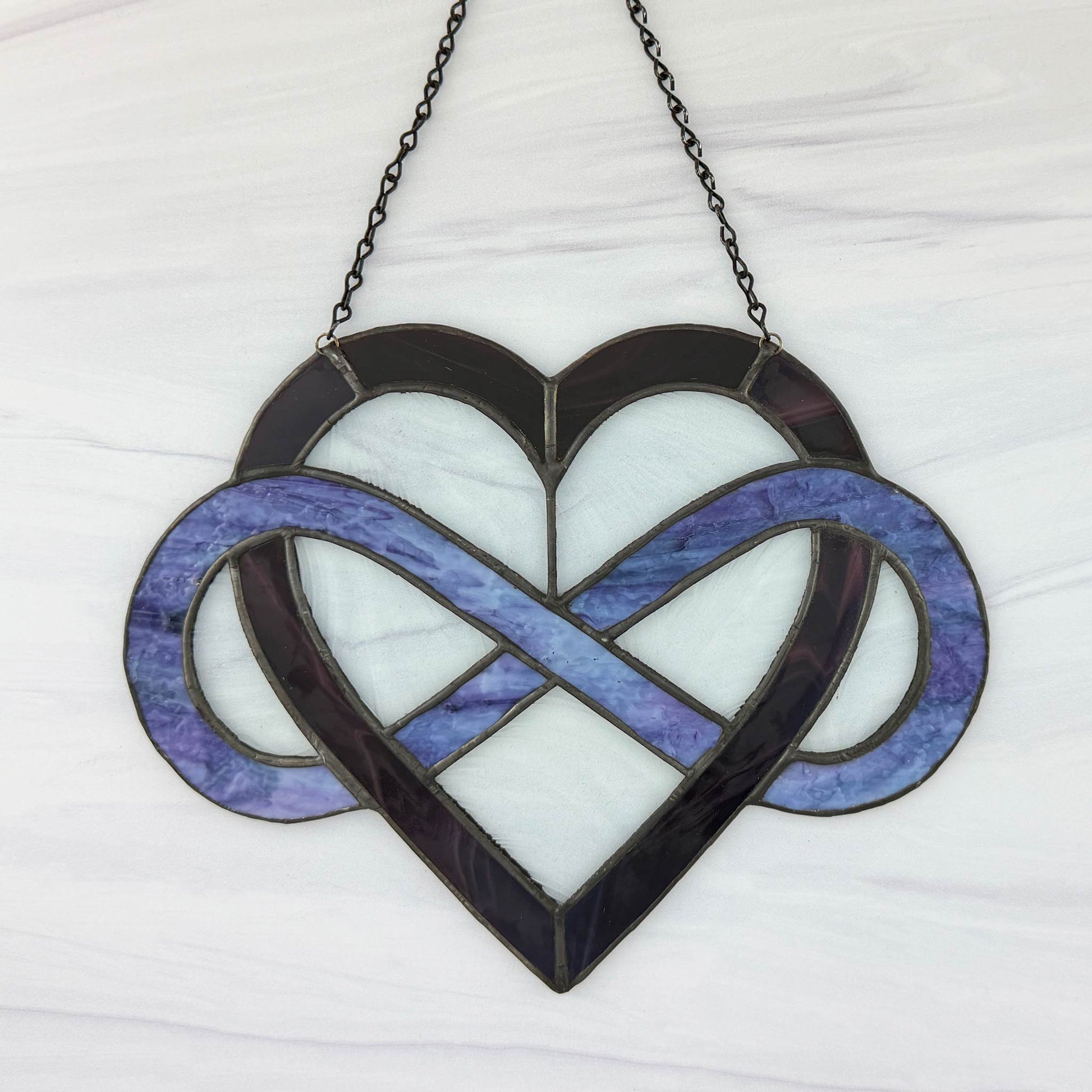 The opposite side of the stained glass heart with infinity symbol suncatcher on a white background