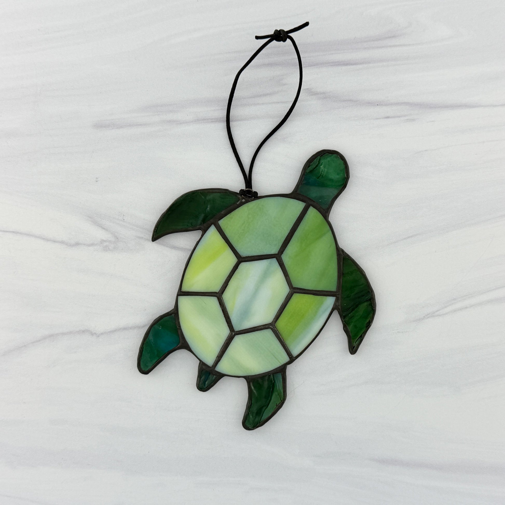 The back side of a Stained glass turtle ornament on a white background