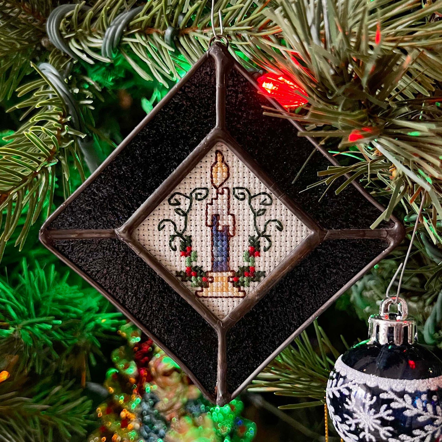 Christmas Candle Ornament with a Dark Blue Sparkle stained glass frame